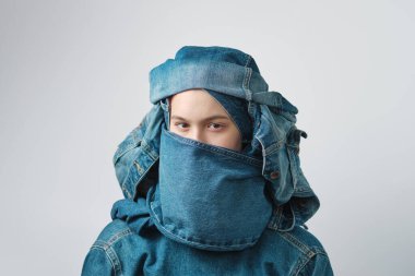 Sarık gibi bir kot başlık giyen bir kızın portresi. Kot pantolon, kot pantolon..