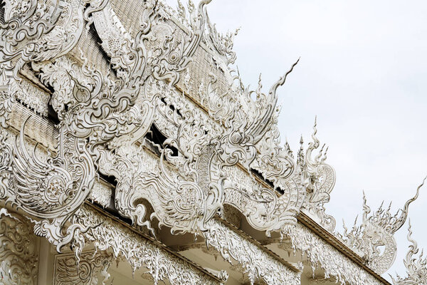 white stucco wall on the roof of temple.