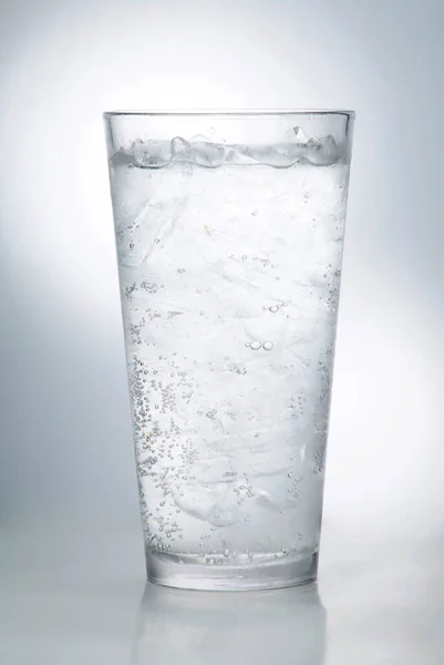 glass of water on a light gray background