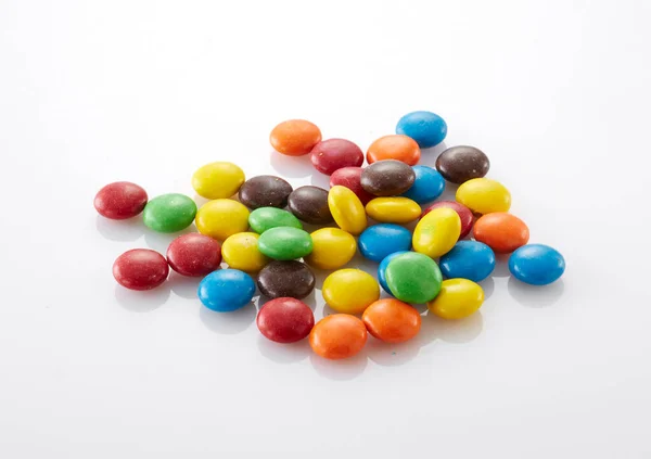 colorful chocolate candies in a bowl. top view.