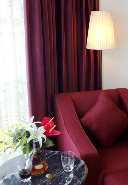 Kırmızı kanepesi ve kahvesi olan lüks bir oturma odası.