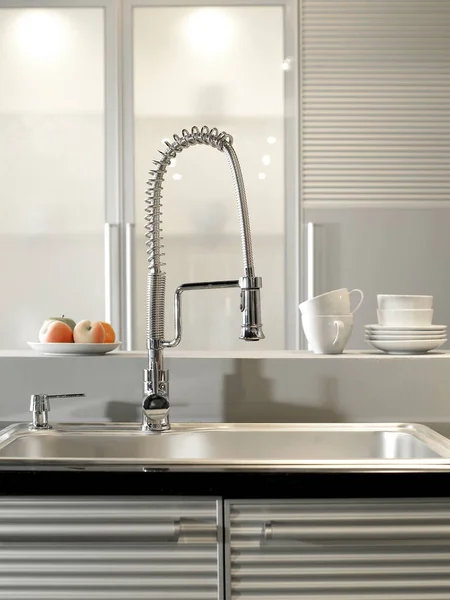 modern kitchen sink with water tap on table in kitchen, closeup