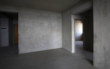 Duvarları ve kirli zemini olmayan boş bir apartman dairesi.