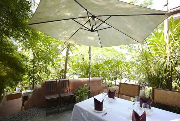 beautiful outdoor patio with table and umbrella