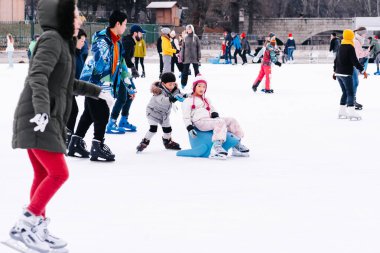 04.01.2022.Budapest.Happy little boy and girl learning to skate in winter.Hobbies and Leisure.Winter sports.Family winter sport.Holiday and seasonal concept.Activity,Adult,Child,Childhood, Daughter.
