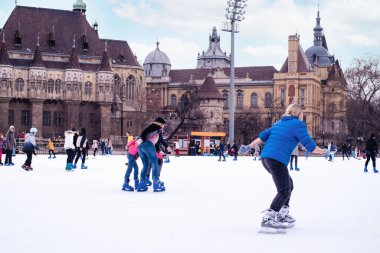 04.01.2022.Budapest.Family winter sport. Family winter sport. Soft,Selective focus.Outdoor.Learning how to skating on ice.Winter sport.Hobbies and Leisure.Winter sports.