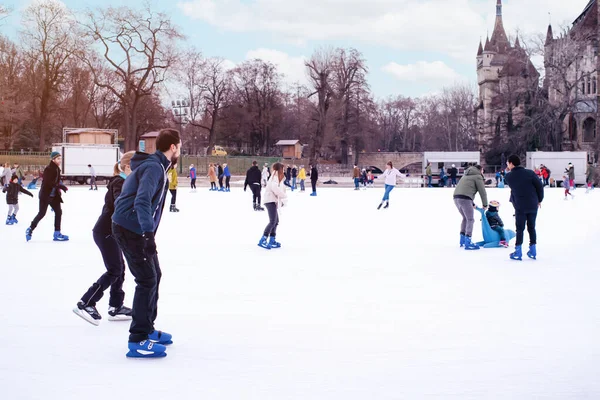 04.01.2022.Budapest.Winter sports.Family winter sport.Holiday and seasonal concept.Activity,Adult,Child,Childhood, Daughter.Happy little boy and girl learning to skate in winter.Hobbies and Leisure.