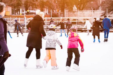 Family winter sport. Family winter sport. Soft,Selective focus.Outdoor.Learning how to skating on ice.Winter sport.Hobbies and Leisure.Winter sports.