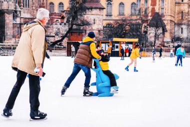 04.01.2022.Budapest.Family winter sport.Sports and fun pastime.Happy little boy and girl learning to skate in winter.People ride on the skating rink on the ice rink during the Christmas holidays.