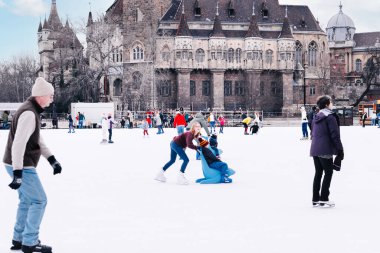 04.01.2022.Budapest.Happy little boy and girl learning to skate in winter.Hobbies and Leisure.Winter sports.Family winter sport.Holiday and seasonal concept.Activity,Adult,Child,Childhood, Daughter.