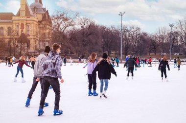 04.01.2022.Budapest.Family winter sport. Soft,Children and adults go ice skating on a winter day at an outdoor skating rink on the street.Selective focus.Outdoor.Winter sport.