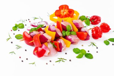 Uncooked mixed meat skewer with peppers.Chicken Skewers meat.Skewers with pieces of raw meat, red, yellow pepper.Top view.Raw chicken leg meat skewers with vegetables,peppers, onions,white background.