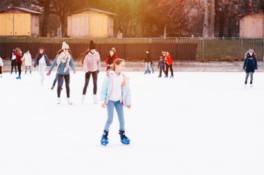 04.01.2022 Budapeşte Aile Kış Sporu. Sık sık, seçici bir odak noktası. İnsanlar buz pateni pistinde kayıyor..