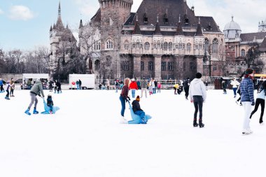 04.01.2022.Budapest.Family winter sport.Holiday and seasonal concept.Happy little boy and girl learning to skate in winter.Hobbies and Leisure.Winter sports.Activity,Adult,Child,Childhood, Daughter.