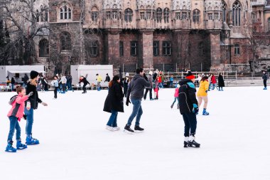 04.01.2022.Budapest.Family winter sport. Family winter sport. Soft,Selective focus.Outdoor.Learning how to skating on ice.Winter sport.Hobbies and Leisure.Winter sports.
