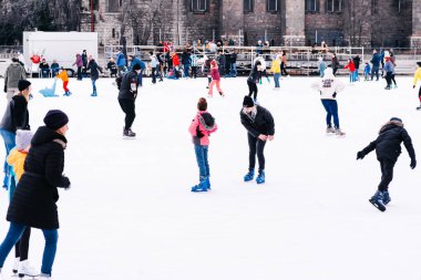 04.01.2022.Budapest.Children and adults go ice skating on a winter day at an outdoor skating rink on the street.Family winter sport. Soft,Selective focus.Outdoor.Winter sport.