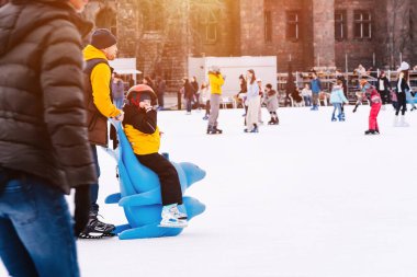 04.01.2022.Budapest.Winter sports.Family winter sport.Holiday and seasonal concept.Activity,Adult,Child,Childhood, Daughter.Happy little boy and girl learning to skate in winter.Hobbies and Leisure.