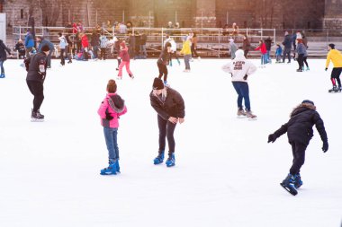 04.01.2022.Budapest.Family winter sport. Family winter sport. Soft,Selective focus.Outdoor.Learning how to skating on ice.Winter sport.Hobbies and Leisure.Winter sports.