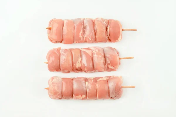 Stock image Chicken skewers.Food for retail.Skewers from raw chicken leg meat without skin for a supermarket on a white background.Chicken meat.Procurement for designers.