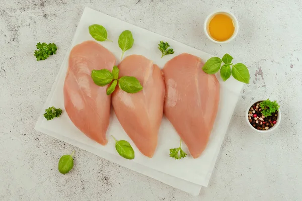 Chicken breast Fillets.Close up.Raw chicken meat.Raw fresh chicken fillet,gray background with fresh herbs.Food for retail.Procurement for designers.Ogranic food,healthy eating.Food concept.Top view.