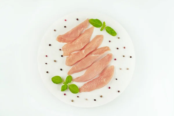 stock image Chicken breast Fillets.Close up.Raw chicken meat.Raw fresh chicken fillet on a white plate with fresh herbs.Copy space.Food for retail.Ogranic food,healthy eating.Food concept.Top view.