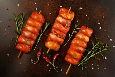 Tavuk şişleri. Taze marine edilmiş derisiz tavuk bacağı. Siyah otlu et şişleri. Tasarımcılar için tedarik..
