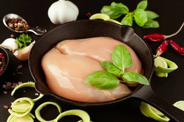 Chicken breast Fillets.Raw fresh chicken fillet with fresh herbs on a black background.Food for retail.Ogranic food,healthy eating.Food concept.Top view.Close up.Raw chicken meat.