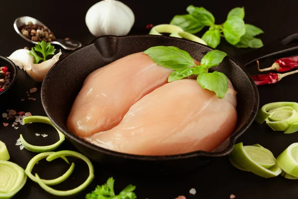 Chicken breast Fillets.Raw fresh chicken fillet with fresh herbs on a black background.Food for retail.Ogranic food,healthy eating.Food concept.Top view.Close up.Raw chicken meat.