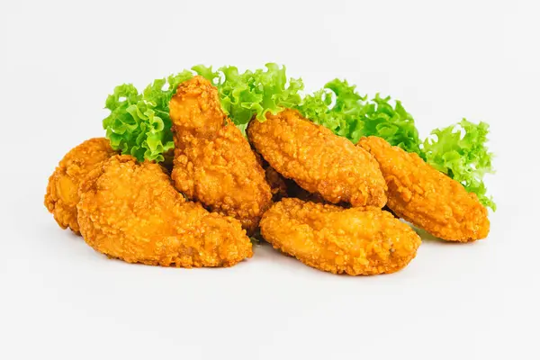 Semi-finished product, fried wings.Breaded Chicken wings with salad on a White Background,food at home.Fast homemade food.Chicken Breaded Raw Meat. Fast cooking.