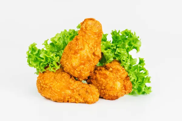 Semi-finished product, fried wings.Breaded Chicken wings with salad on a White Background,food at home.Fast homemade food.Chicken Breaded Raw Meat. Fast cooking.