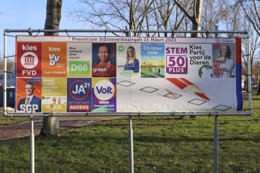 Netherlands, March 2023 -Board with election posters for the provincial and water board elections in the Netherlands for coming elections clipart