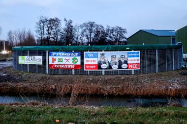 Netherlands, March 2023 -Board with election posters at farm with protest signs and anti coalition banners by angry farmer in Waddinxveen clipart