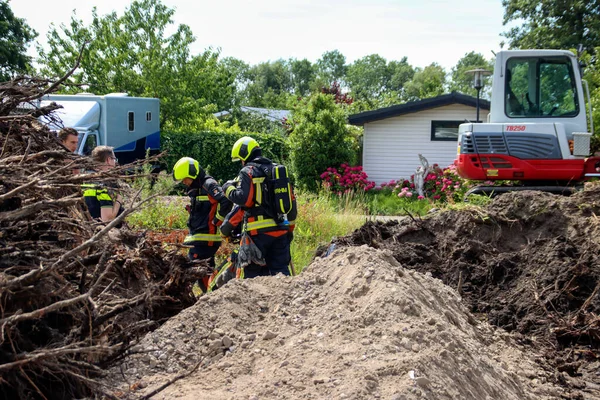 stock image Firefighters must take action if a gas pipe is hit during excavation work at Park de IJsselhoeve in Nieuwerkerk aan den IJssel the Netherlands