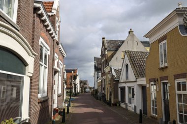 Hollanda 'daki Hollandsche IJssel nehri boyunca Dyke' ın bir parçası olarak Moordrecht köyündeki Dorpsstraat 'ta eski evler