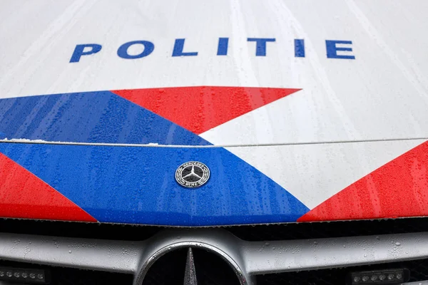 Logo and striping in front of dutch police (politie) car in the Netherlands