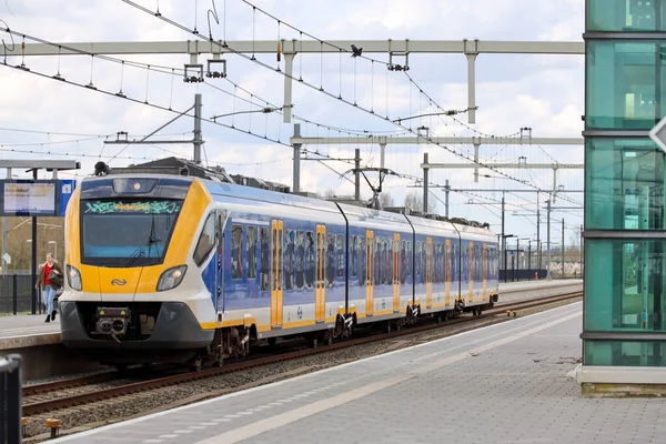 stock image SNG local commuter train build by CAF on track in Lage Zwaluwe running for NS in the Netherlands