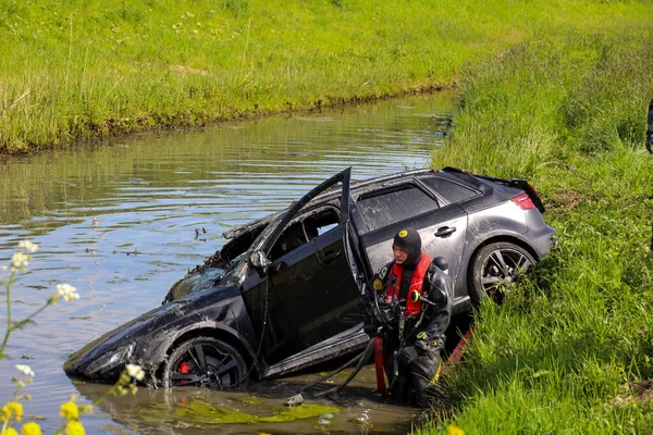 stock image rental car upside down after driver lost control of the wheel from a wedding procession in Waddinxveen