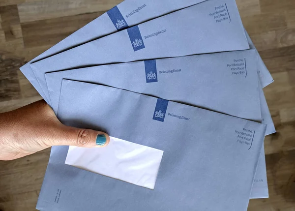 stock image Blue envelope from the Dutch Tax Administration (belastingdienst) containing the tax assessment in the Netherlands