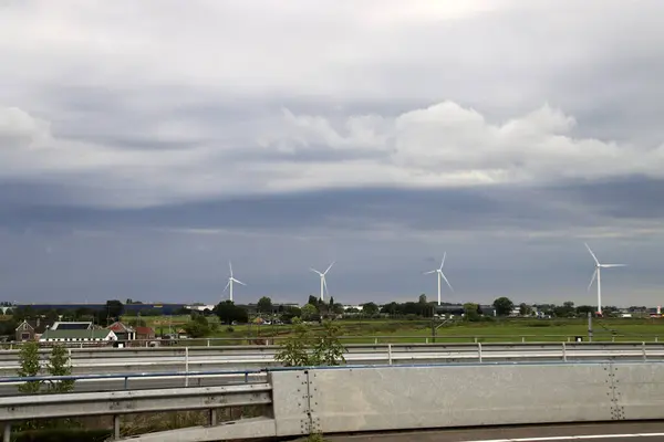 Windmills at meadows in the Zuidplaspolder where new village will be buid
