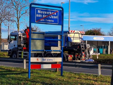 Spreader truck with salt during slipperiness in Nieuwerkerk aan den IJssel South Holland the Neterlands clipart