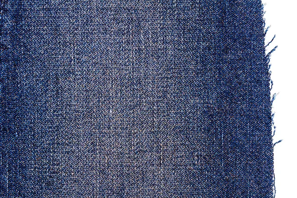 Piece of blue jeans fabric isolated on white background. Rough uneven edges. Denim pants torn.