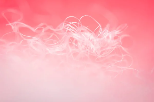 stock image Extreme macro of polyester stable fiber on red background. Selective focus, shallow depth of field. Abstract dreamy background