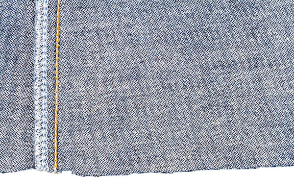 Piece of blue jeans fabric isolated on white background. Rough uneven edges. Denim pants torn. Wrong side of fabric.