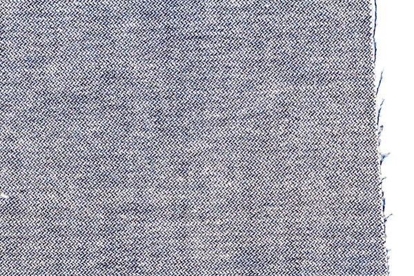 Piece of blue jeans fabric isolated on white background. Rough uneven edges. Denim pants torn. Wrong side of fabric.