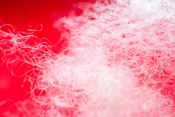 stock image Extreme macro of polyester stable fiber on red background. Selective focus, shallow depth of field. Abstract dreamy background