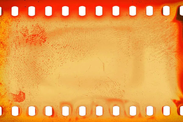 Dusty and grungy 35mm film texture or surface. Perforated scratched camera film isolated on white background.