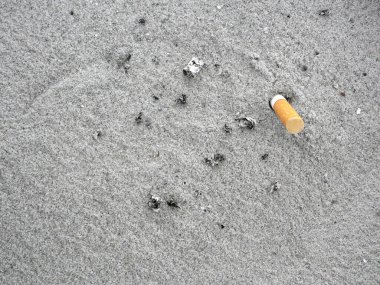 The rest of cigarettes in sand ashtray