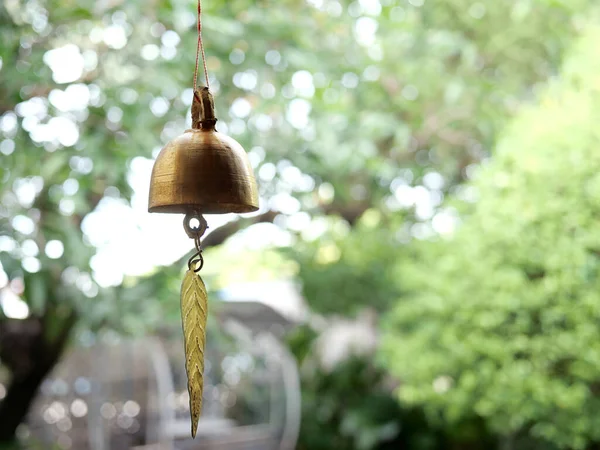 Gold metal bell on bokeh background