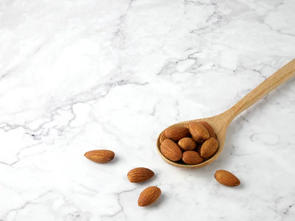 Almonds Wooden Spoon Marble Texture Background — Zdjęcie stockowe