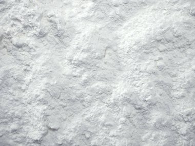 White flour texture background. Abstract powder texture. White powder surface with cracks. 